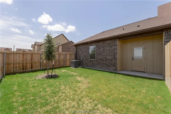 a view of a house with a yard and plants