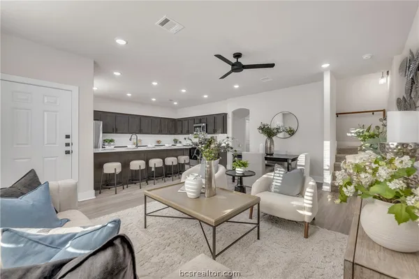 a living room with furniture and a potted plant