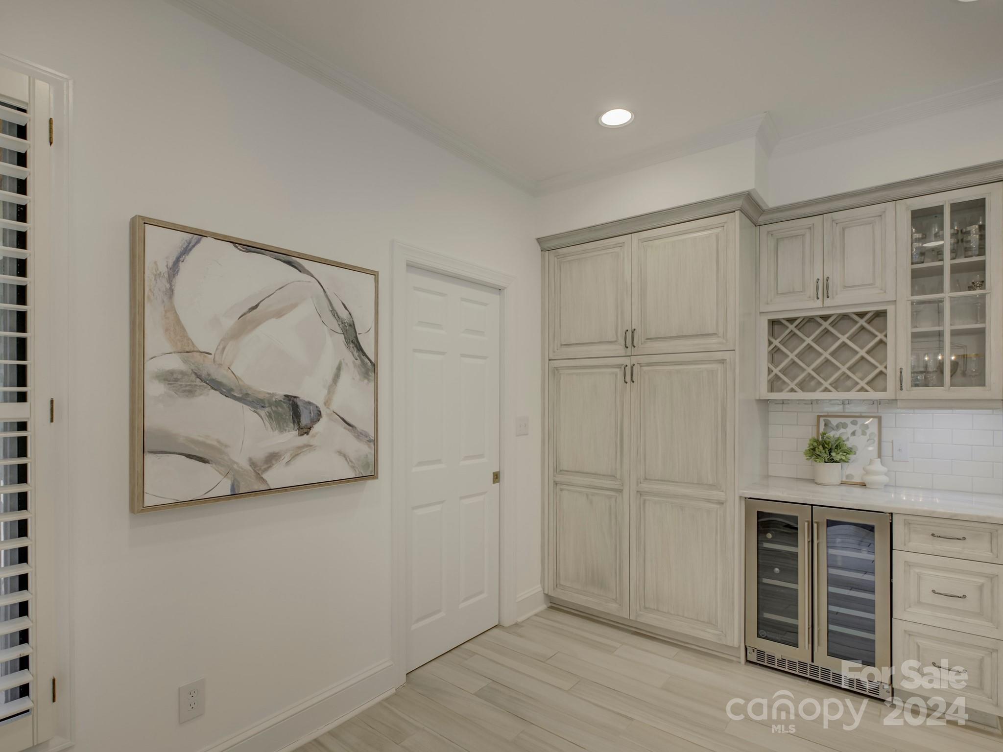 4440 Canoebrook Road Charlotte, NC 28210 - Photo 17 of 47 an empty room with wooden floor and cabinet