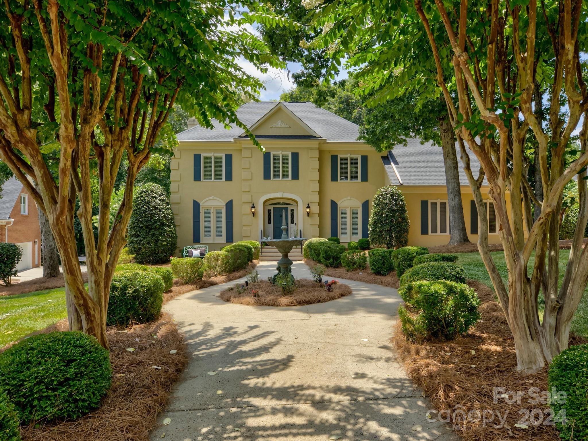 4440 Canoebrook Road Charlotte, NC 28210 - Photo 2 of 47 a front view of a house with a garden