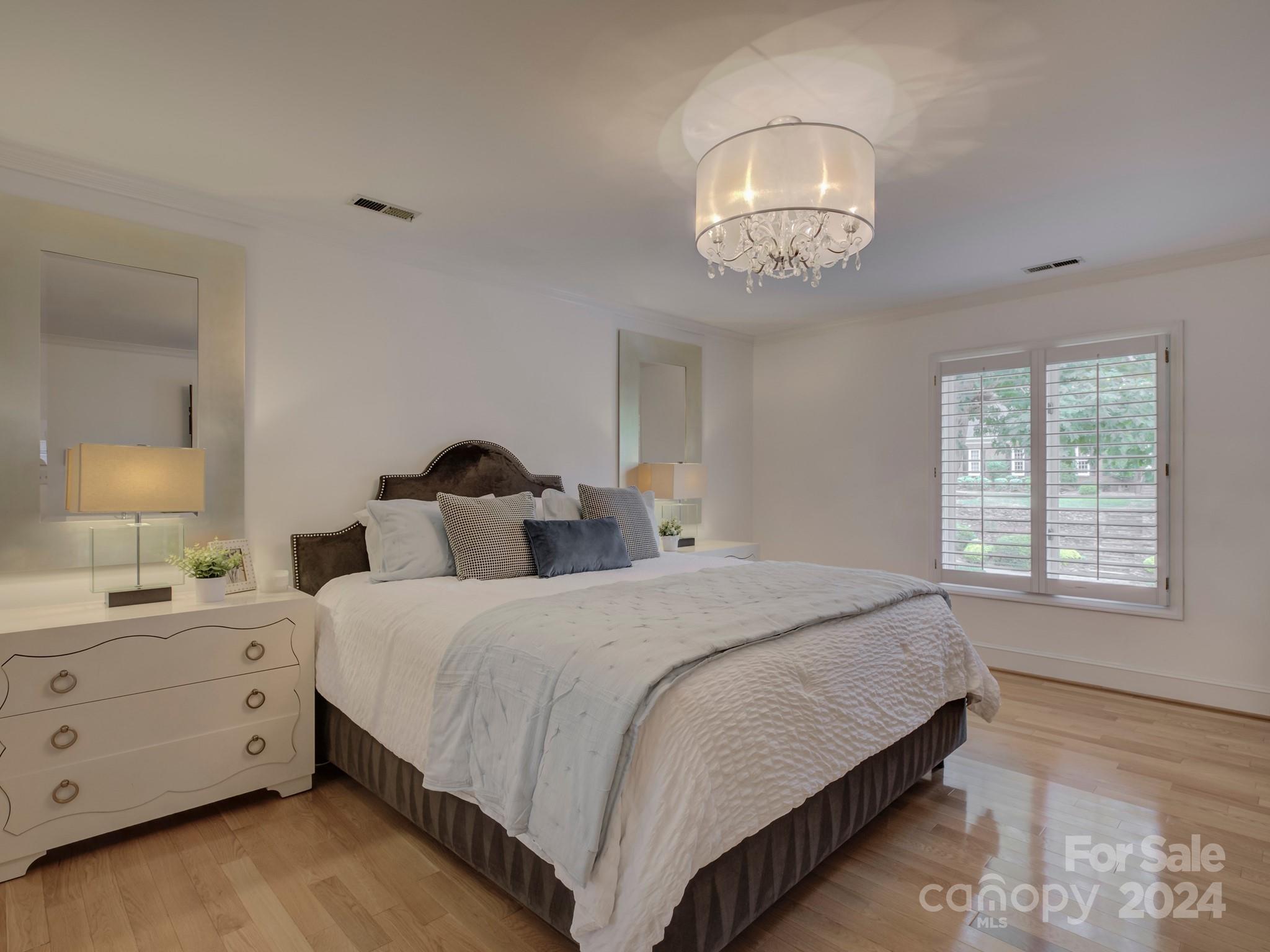 4440 Canoebrook Road Charlotte, NC 28210 - Photo 24 of 47 a bedroom with a bed and a night stand next to a window