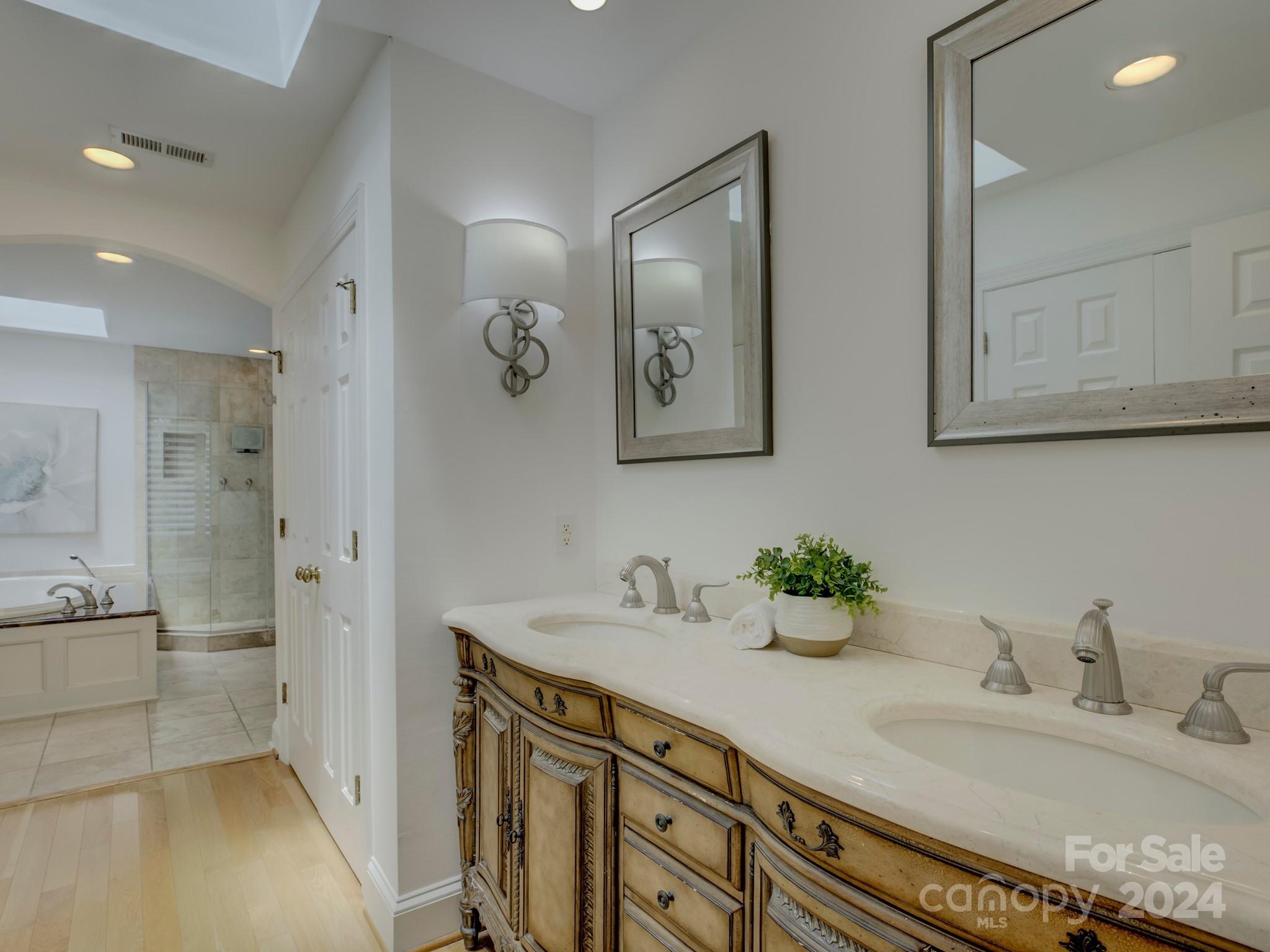 4440 Canoebrook Road Charlotte, NC 28210 - Photo 27 of 47 a bathroom with double vanity sink a mirror and shower