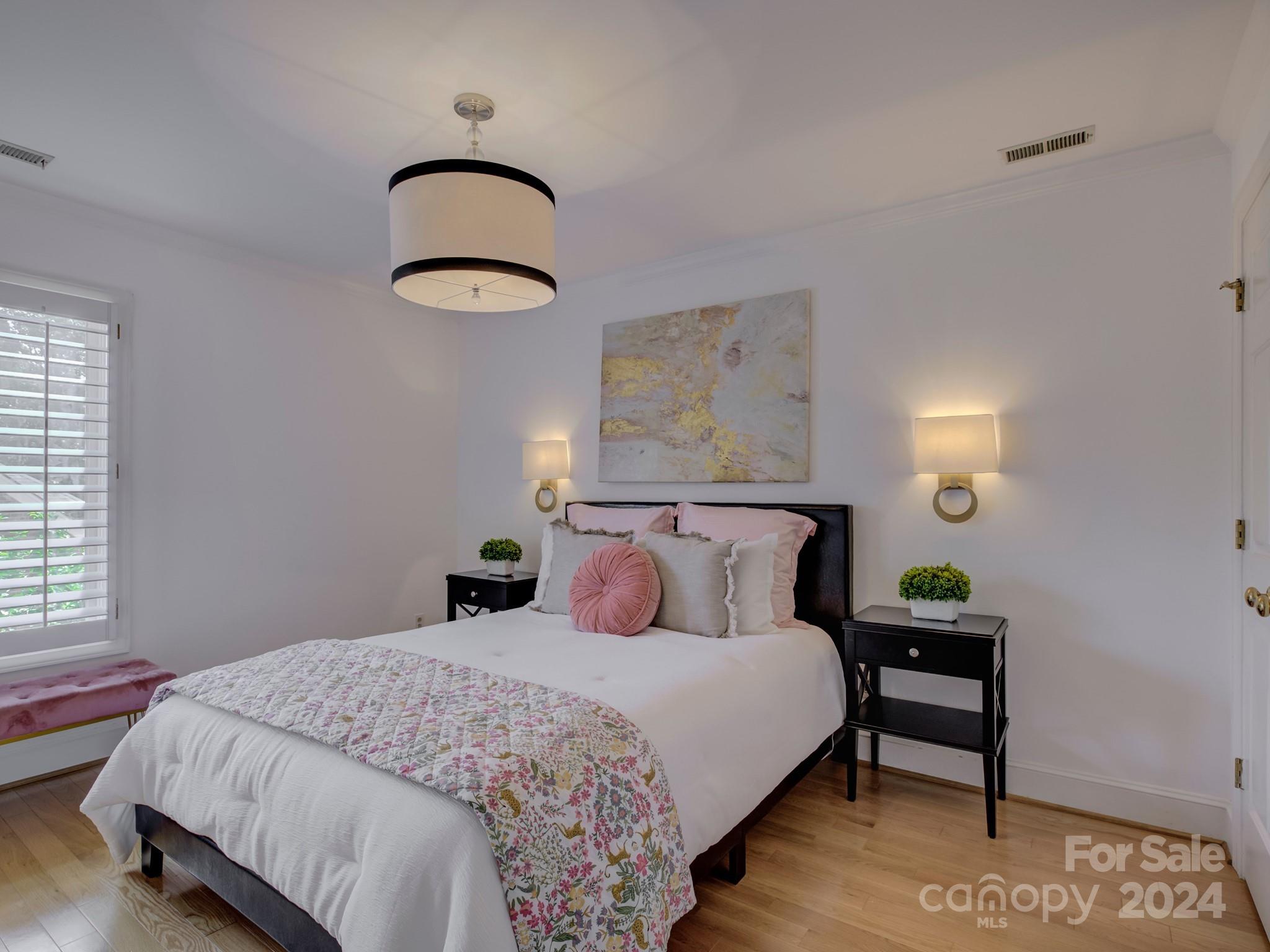 4440 Canoebrook Road Charlotte, NC 28210 - Photo 30 of 47 a bedroom with a bed and a lamp