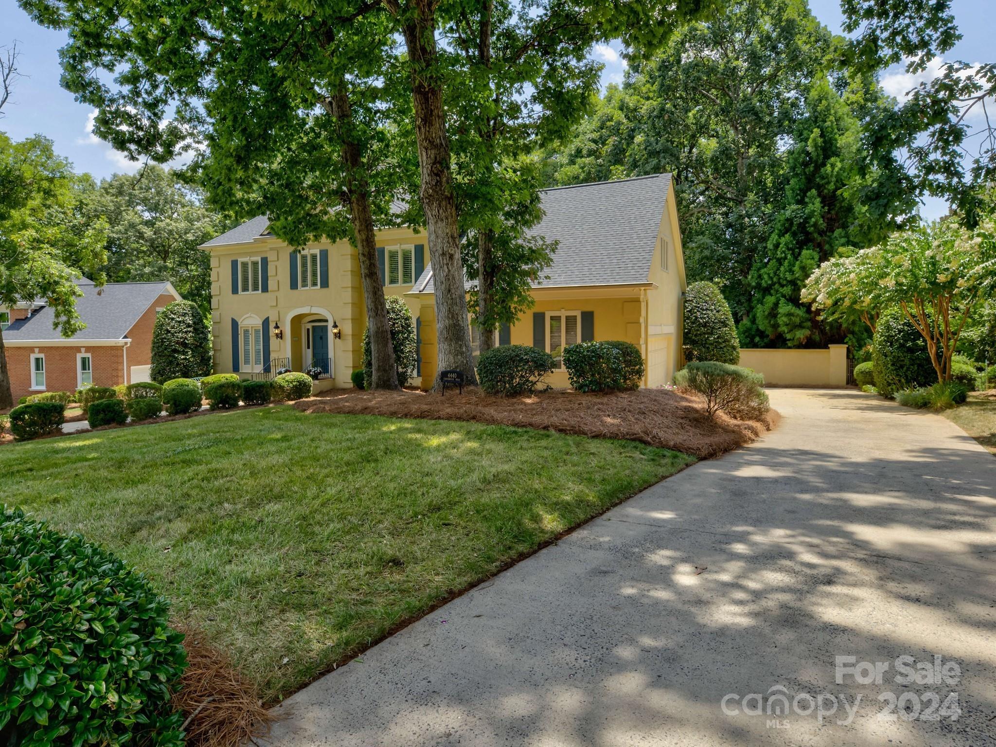 4440 Canoebrook Road Charlotte, NC 28210 - Photo 3 of 47 a front view of a house with a yard and trees