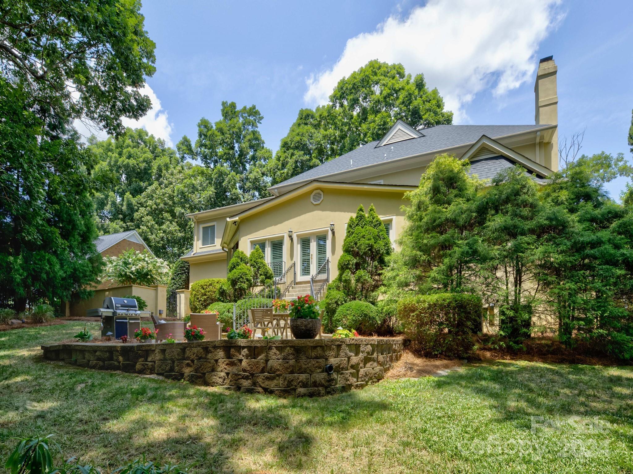 4440 Canoebrook Road Charlotte, NC 28210 - Photo 45 of 47 a view of a house with a yard and sitting area