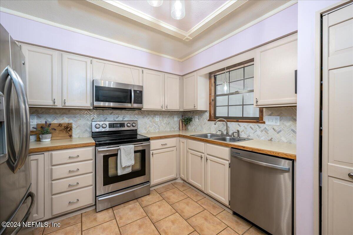 4847 Reed Avenue Jacksonville, FL 32257 - Photo 8 of 36 a kitchen with stainless steel appliances granite countertop a stove top oven a sink dishwasher and a refrigerator with wooden cabinets