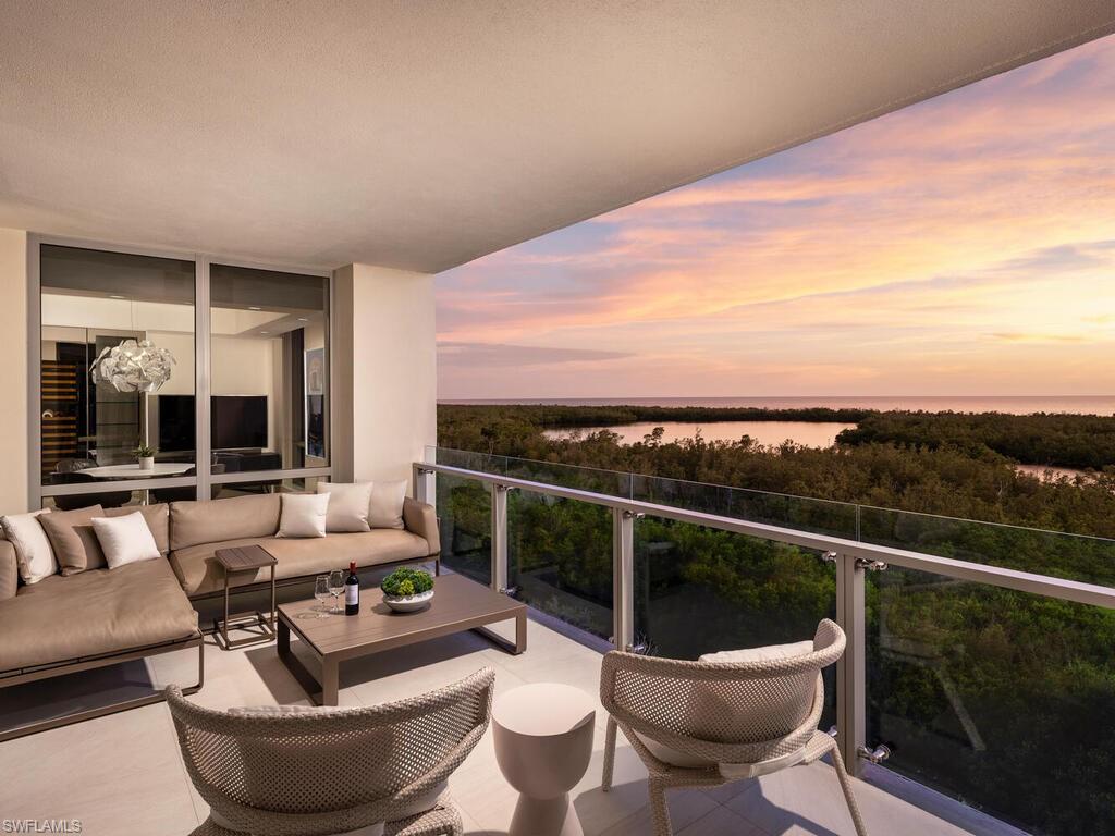 6897 Grenadier Boulevard, Unit 702 Naples, FL 34108 - Photo 2 of 4 a outdoor living space with furniture and a potted plant