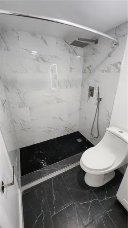 a bathroom with a toilet and a shower