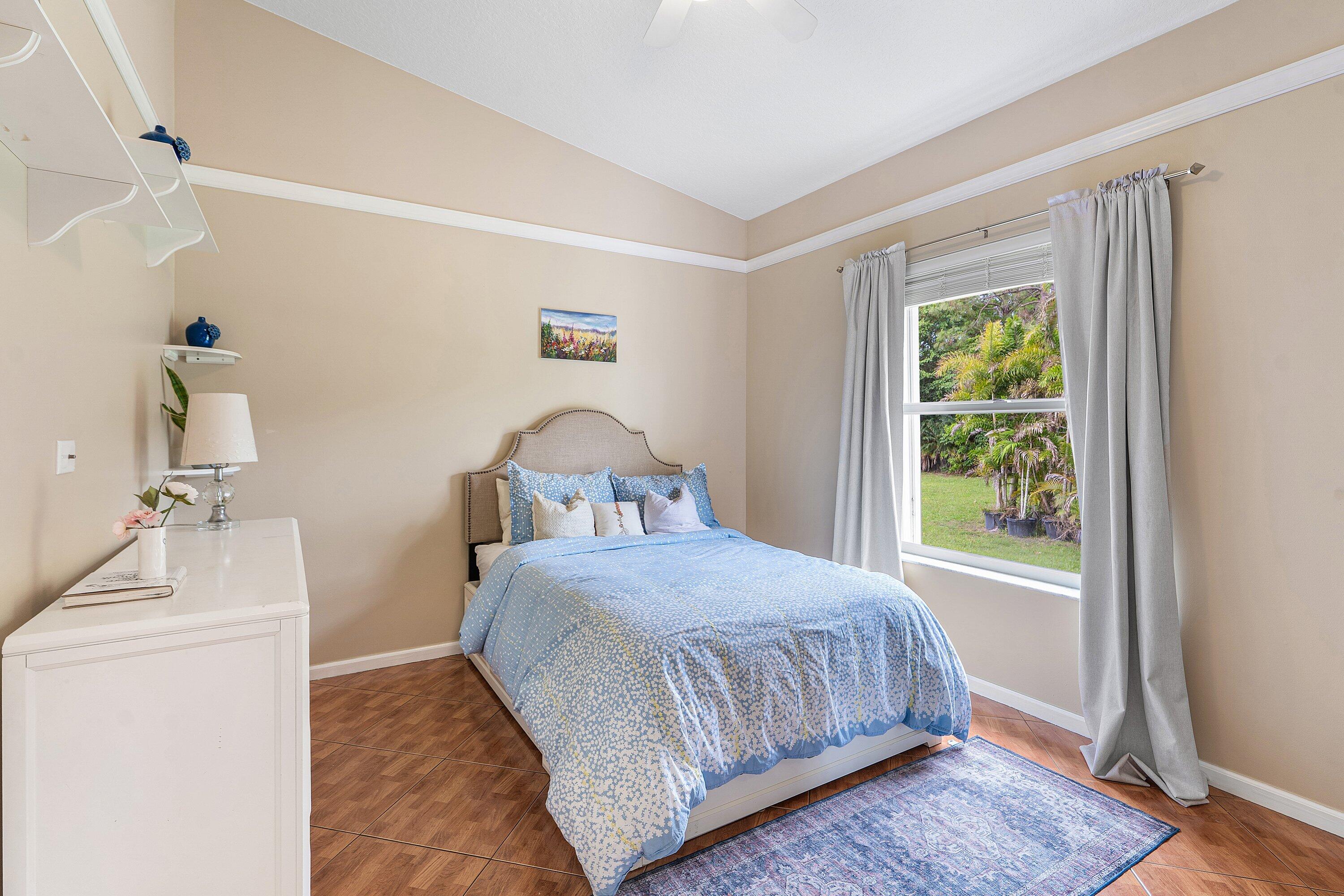 12328 85th Road North West Palm Beach, FL 33412 - Photo 31 of 51 a bedroom with a bed and a window