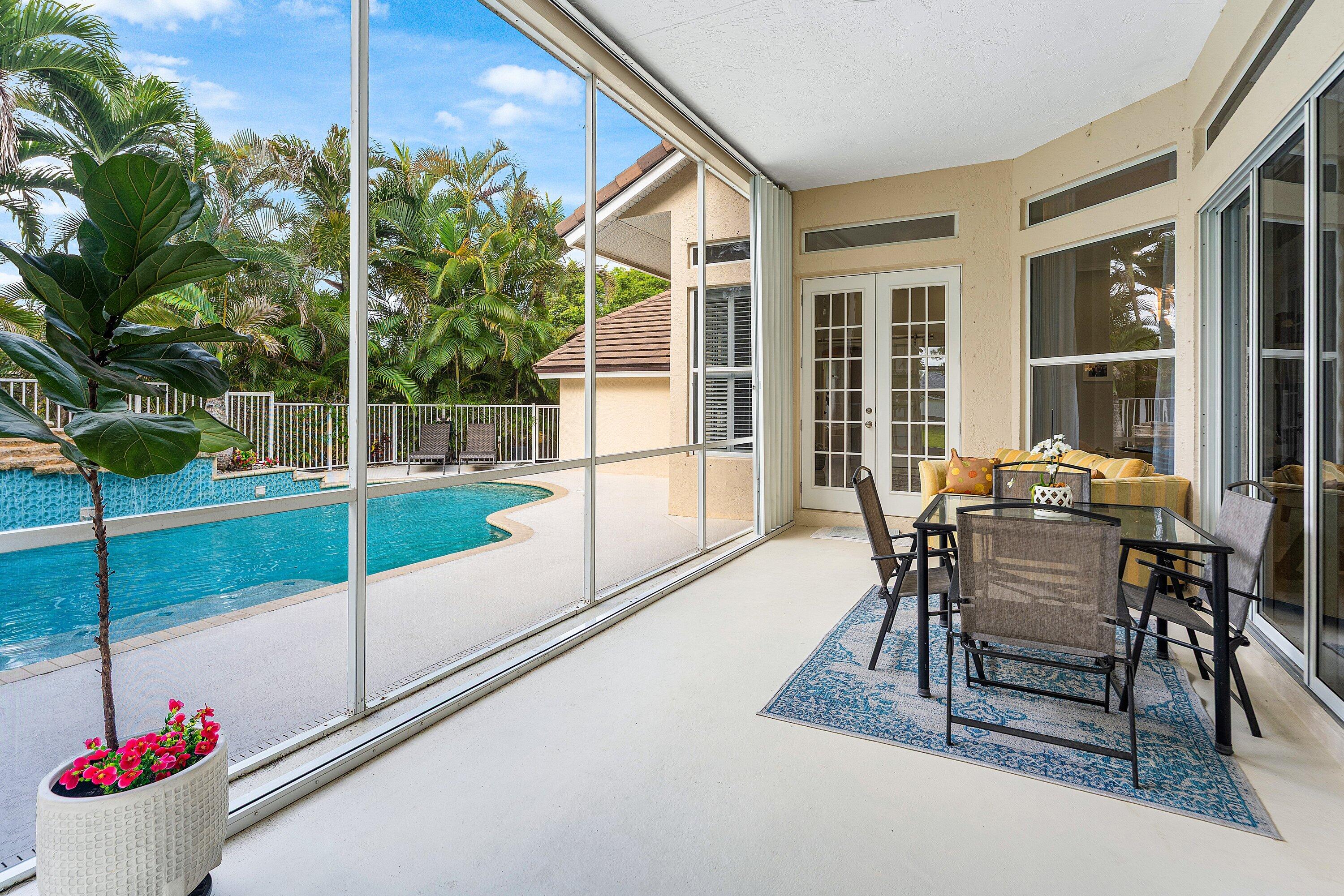 12328 85th Road North West Palm Beach, FL 33412 - Photo 36 of 51 a dining room with furniture and a floor to ceiling window