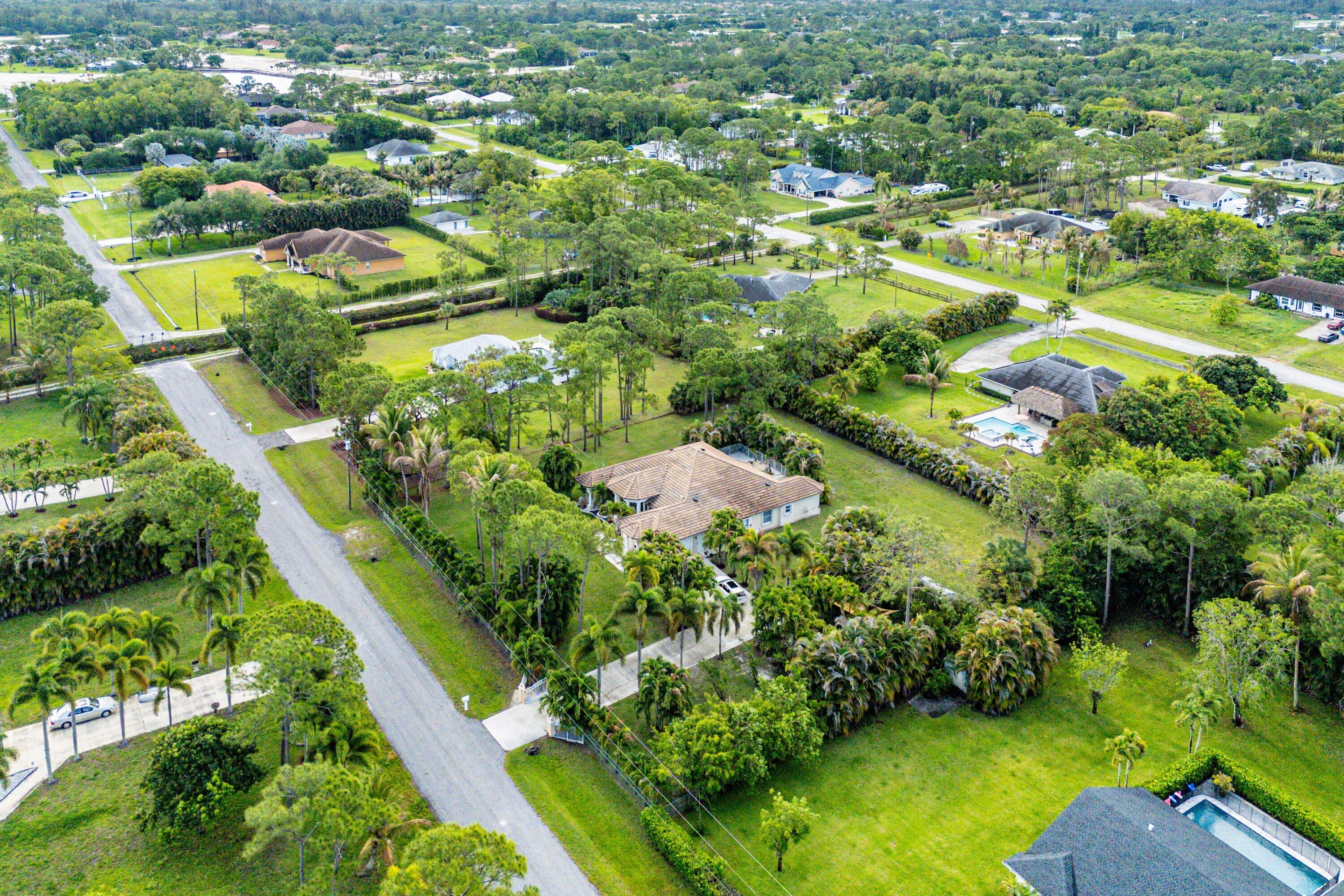 12328 85th Road North West Palm Beach, FL 33412 - Photo 47 of 51 an aerial view of residential houses with outdoor space and trees