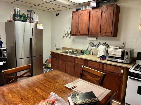 a kitchen with stainless steel appliances granite countertop a refrigerator sink and microwave