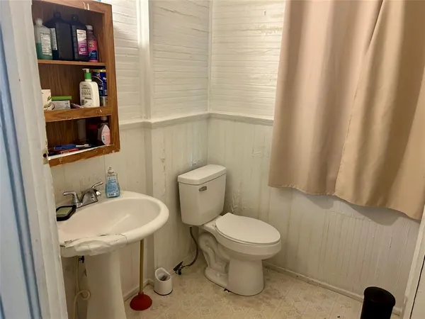 a white toilet sitting next to a bathroom sink