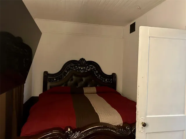 a bedroom with a bed and a closet