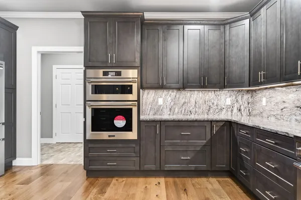 a kitchen with wooden cabinets and a stove top oven