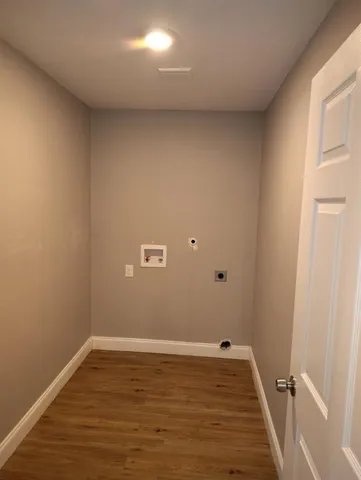 a view of a room with wooden floor