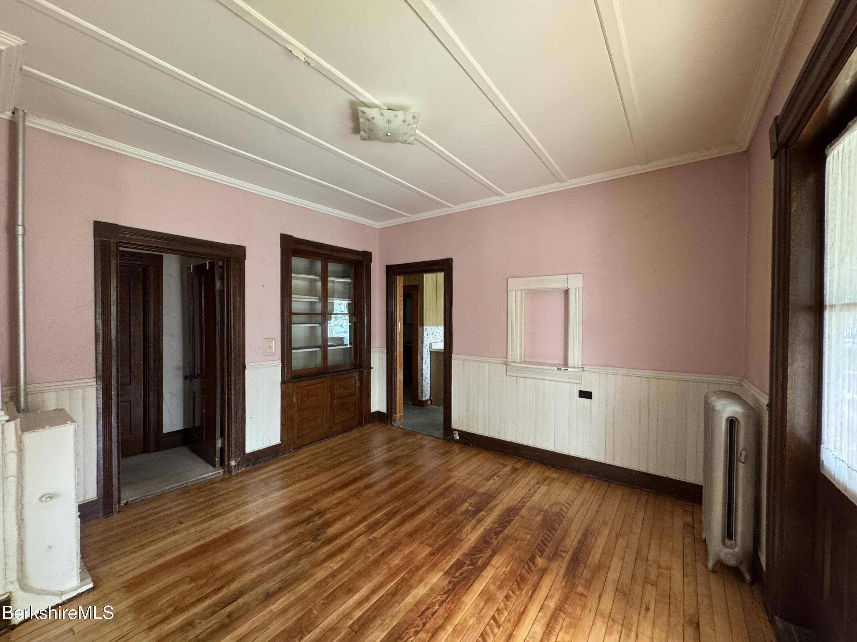 672-676 North Hoosac Road Williamstown, MA 01267 - Photo 4 of 14 a view of an empty room with wooden floor and a window
