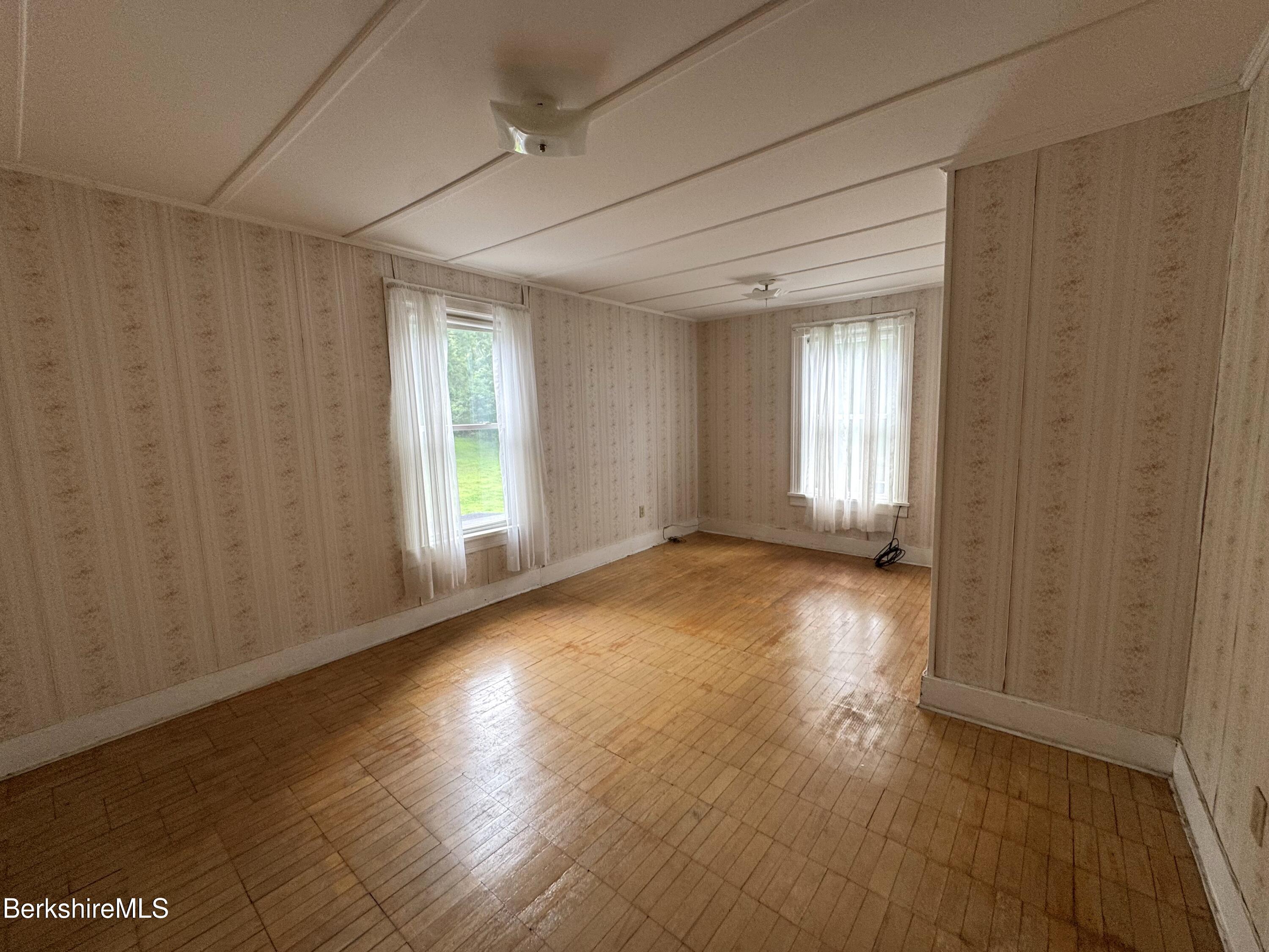 672-676 North Hoosac Road Williamstown, MA 01267 - Photo 9 of 14 a view of empty room with wooden floor and fan