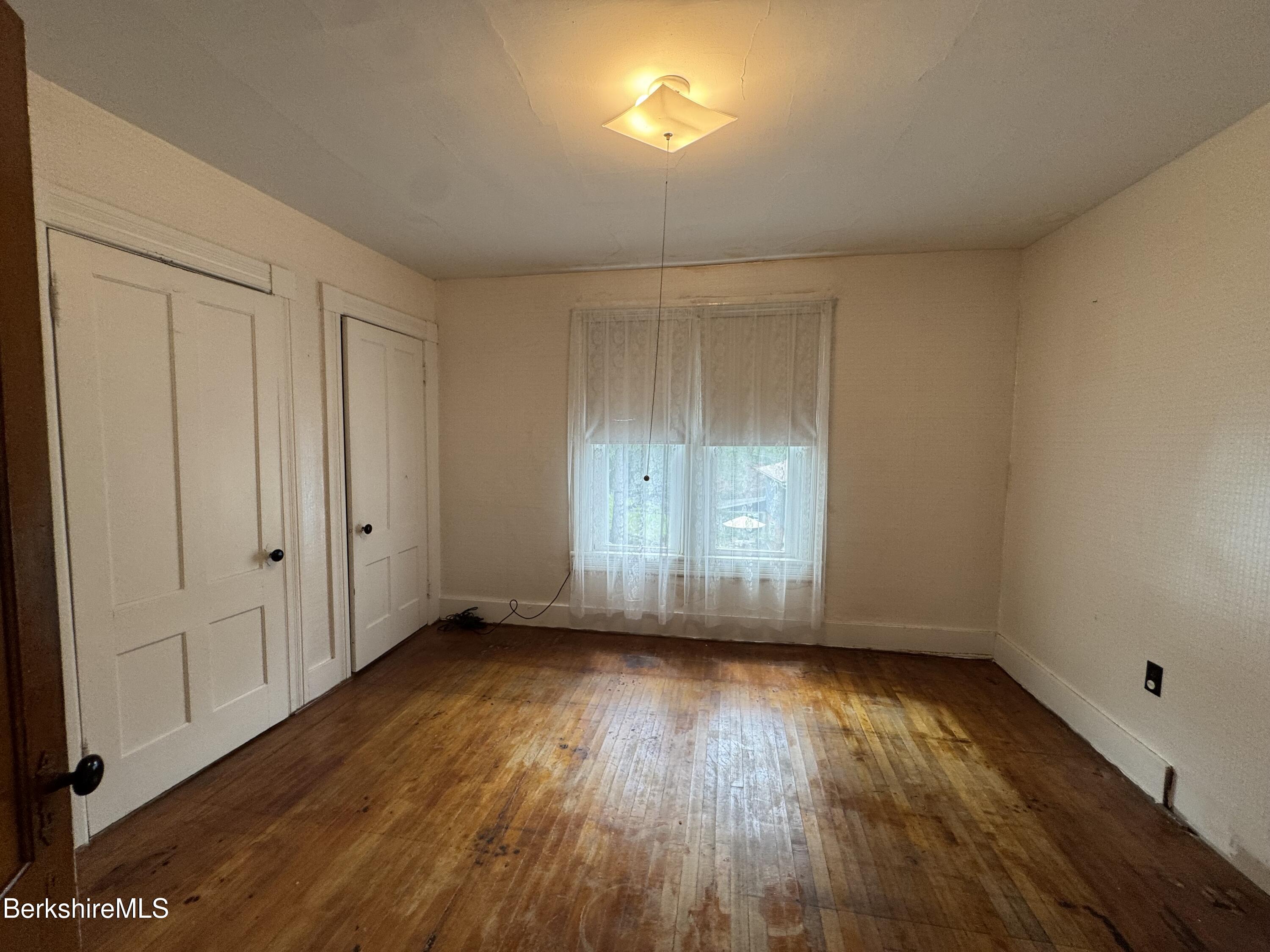 672-676 North Hoosac Road Williamstown, MA 01267 - Photo 10 of 14 an empty room with wooden floor and windows