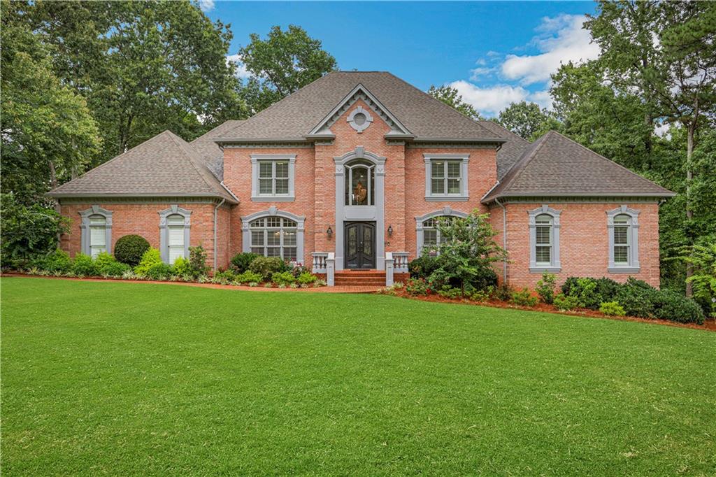 a front view of a house with a garden