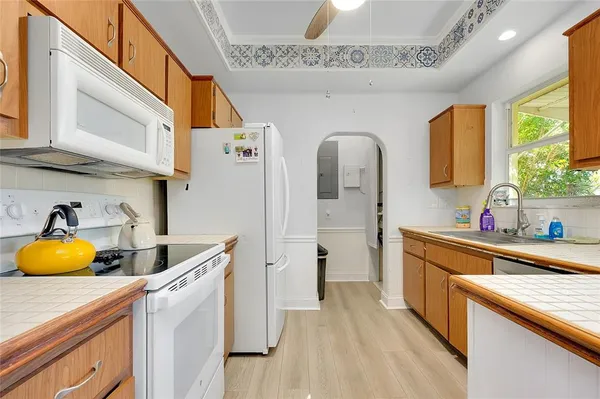 a kitchen with a sink cabinets and window