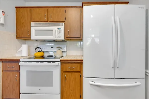 a kitchen that has a sink a stove and a wooden floor