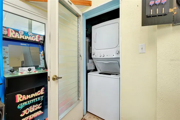 a bedroom with a bed and a flat tv screen on the dresser