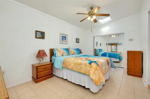a bed sitting in a bedroom and a chandelier