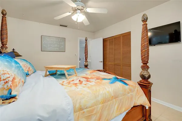 a bedroom with a bed and a flat screen tv