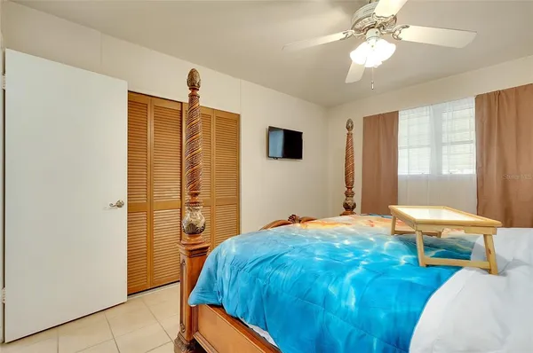 a bedroom with a bed and a chandelier