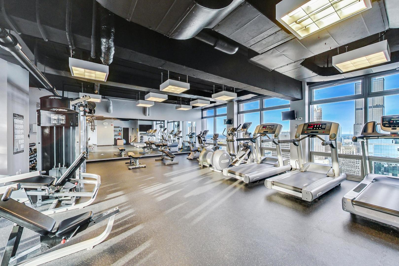 65 East Monroe Street, Unit 4521 Chicago, IL 60603 - Photo 18 of 25 a view of a gym with lots of gym equipment