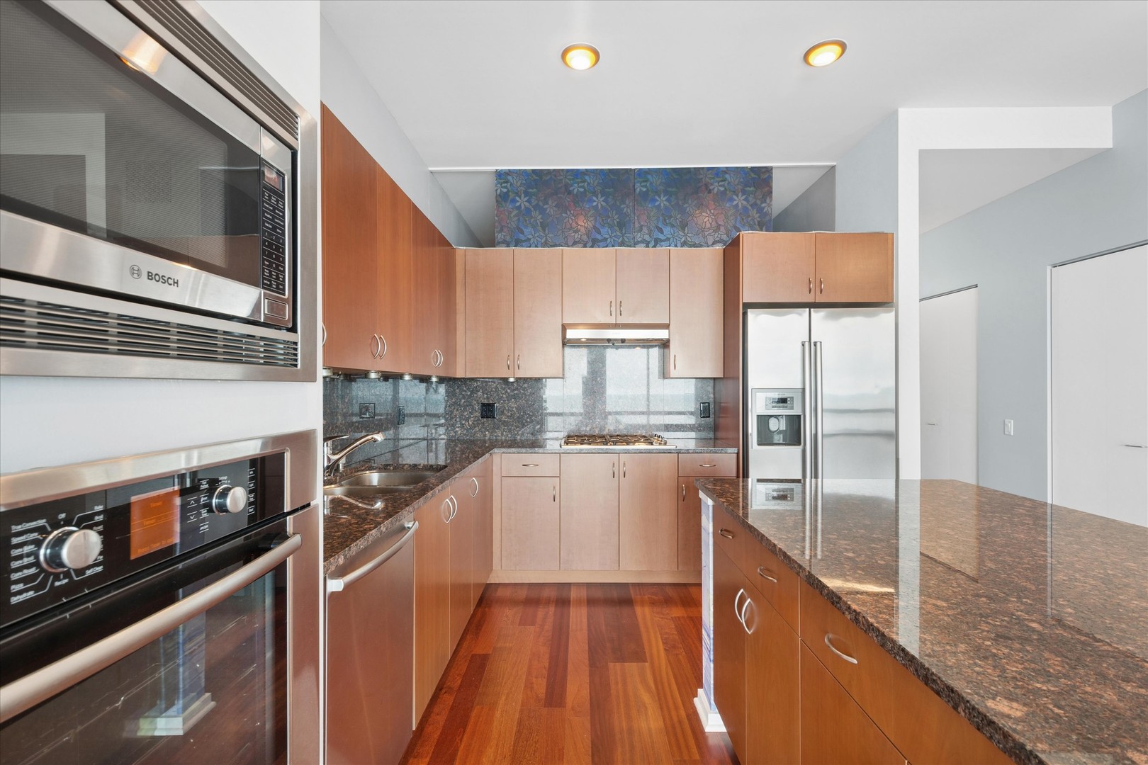 65 East Monroe Street, Unit 4521 Chicago, IL 60603 - Photo 4 of 25 a kitchen with stainless steel appliances granite countertop a stove a sink and a refrigerator