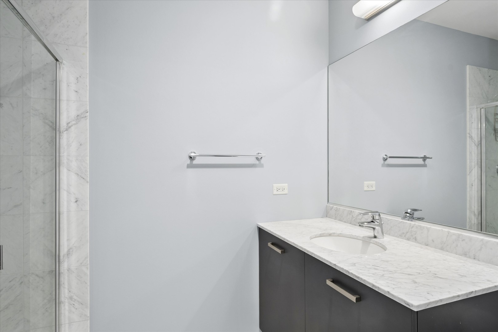 65 East Monroe Street, Unit 4521 Chicago, IL 60603 - Photo 10 of 25 a bathroom with a granite countertop sink and a mirror