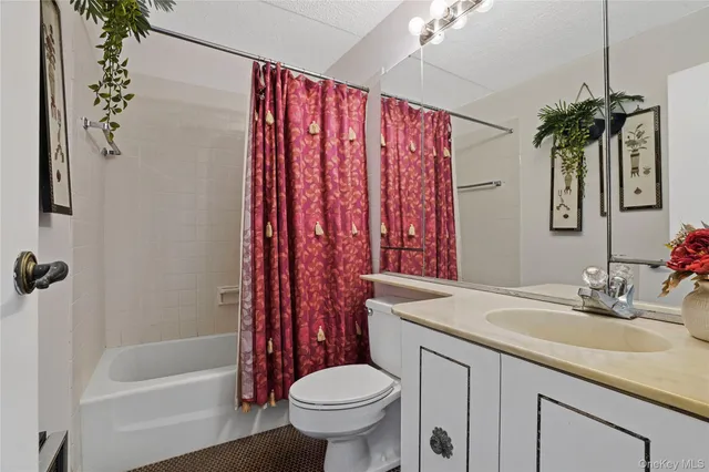 a bedroom with a bed a desk and chair with the wooden floor