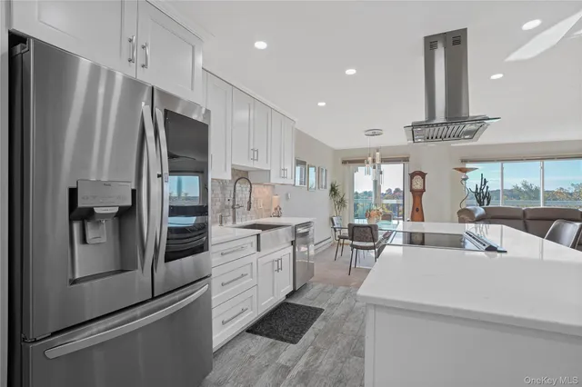 a kitchen with white cabinets and stainless steel appliances