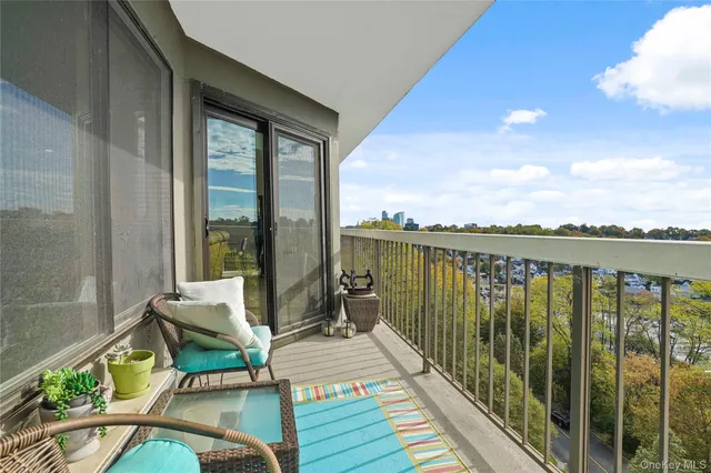 a balcony with chairs and a table