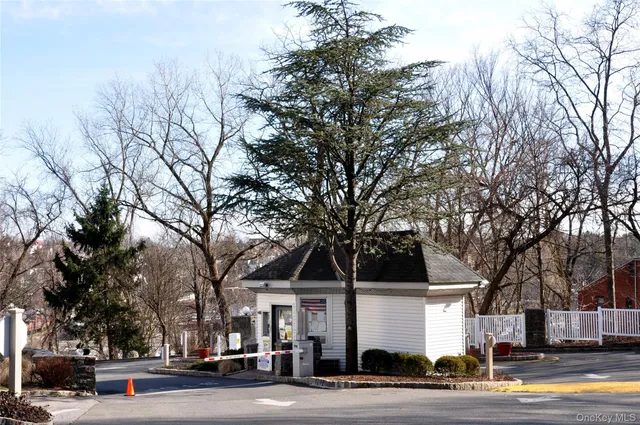 a front view of a building with trees