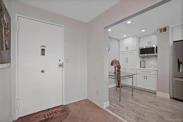 a kitchen with stainless steel appliances granite countertop a refrigerator a stove and a sink