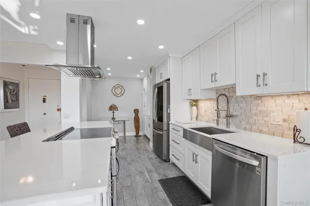 a kitchen with a refrigerator and a stove top oven