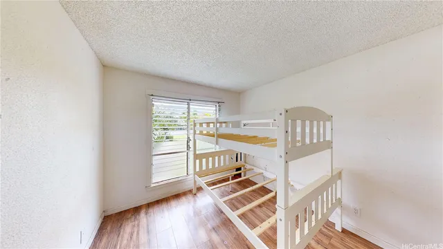 a walk in closet with wooden floor