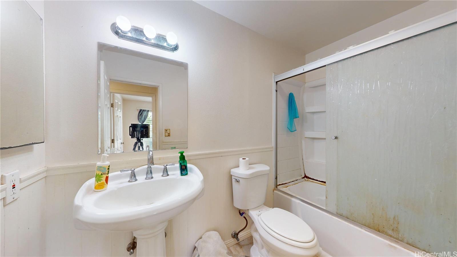 92-1244 Kikaha Street, Unit 14 Kapolei, HI 96707 - Photo 17 of 25 a white toilet sitting next to a bathroom sink