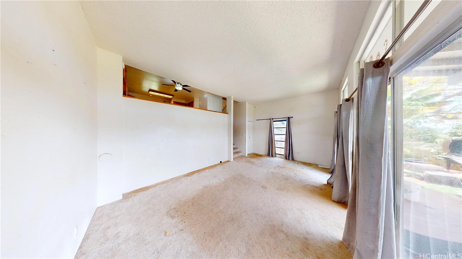 92-1244 Kikaha Street, Unit 14 Kapolei, HI 96707 - Photo 2 of 25 a view of a livingroom with wooden floor and windows