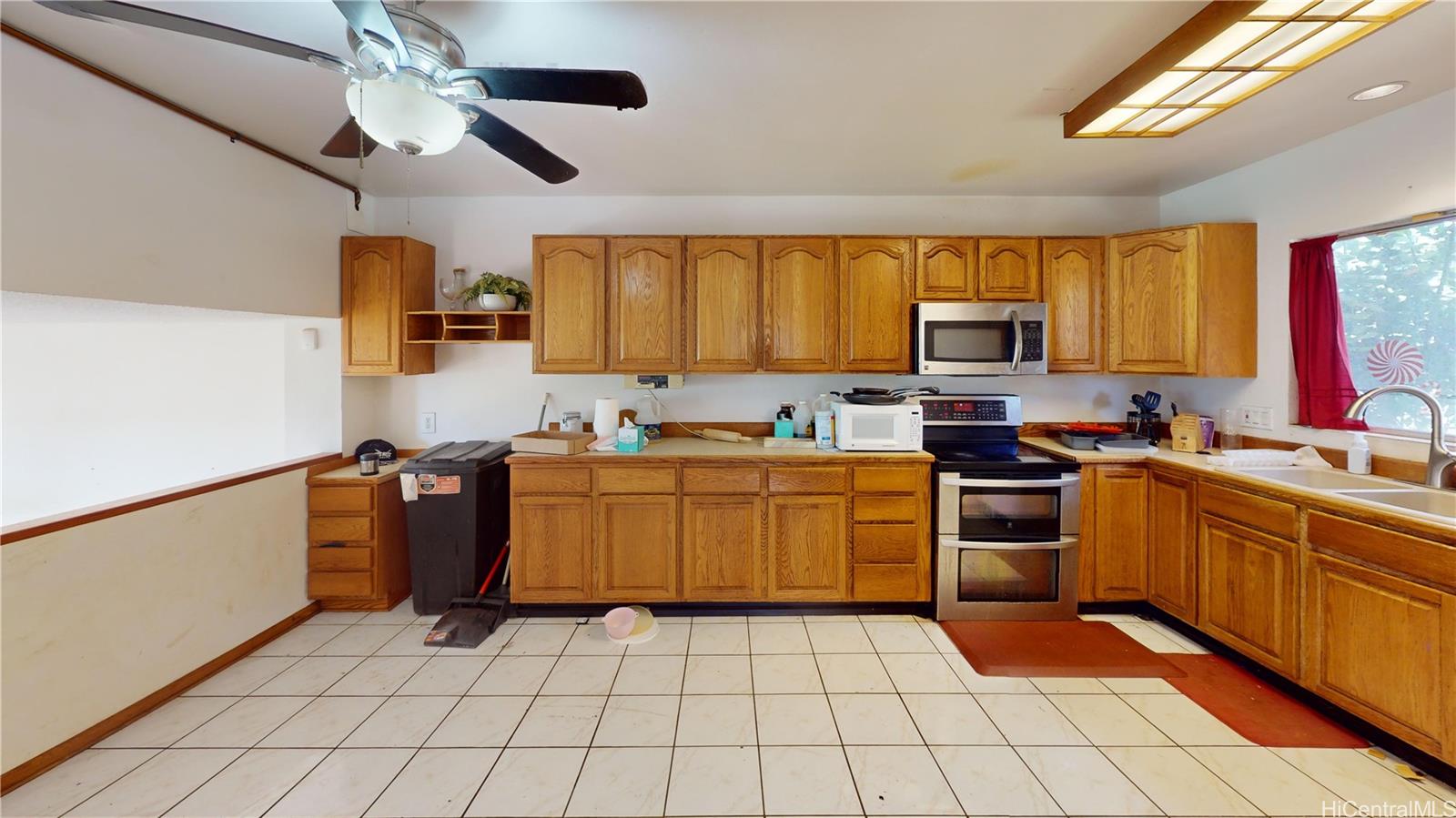 92-1244 Kikaha Street, Unit 14 Kapolei, HI 96707 - Photo 4 of 25 a kitchen with a sink a stove cabinets and appliances