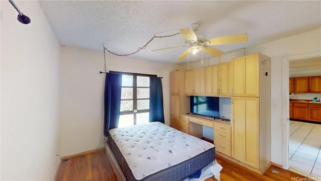 a kitchen view with wooden floor and a window