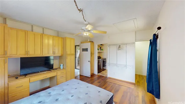 a view of a kitchen with kitchen island a sink stainless steel appliances and cabinets