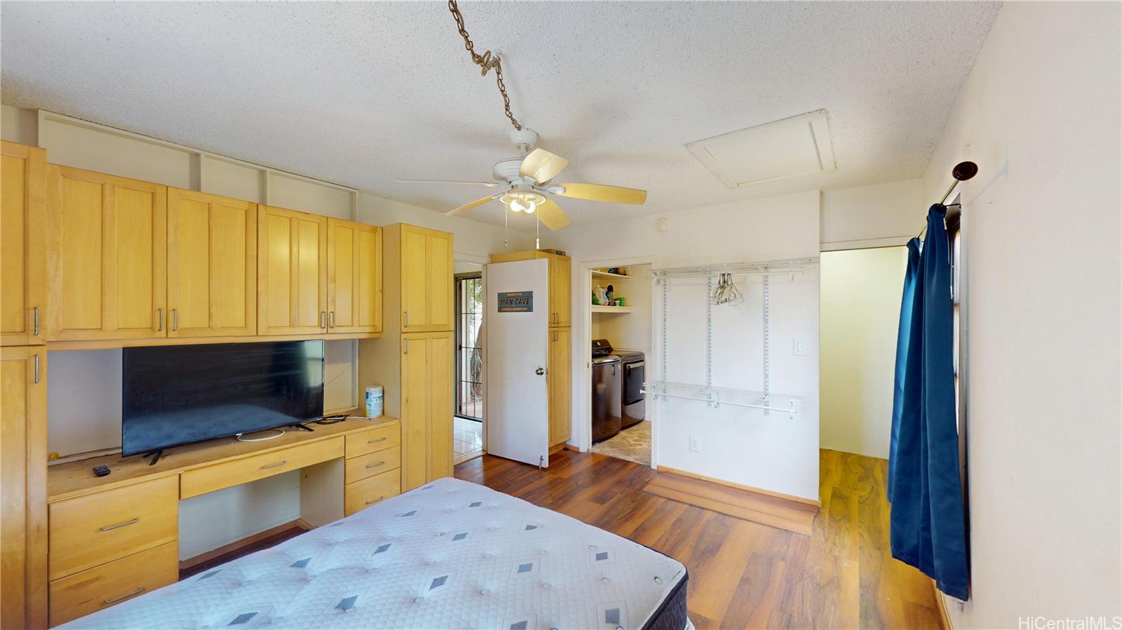 92-1244 Kikaha Street, Unit 14 Kapolei, HI 96707 - Photo 7 of 25 a view of a kitchen with kitchen island a sink stainless steel appliances and cabinets