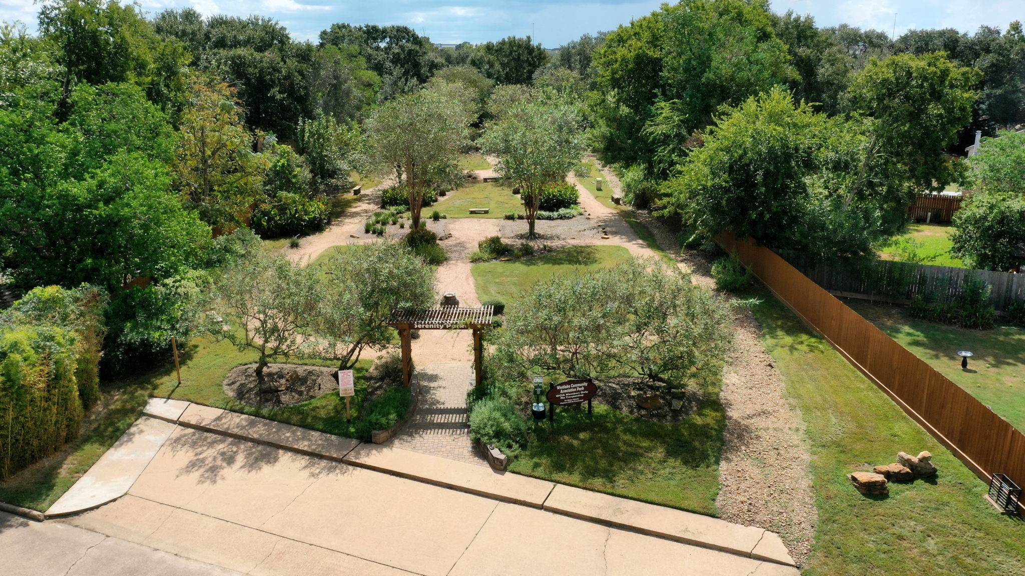 19519 Ricelake Lane Houston, TX 77084 - Photo 44 of 47 Serene garden oasis with lush trees and winding paths, perfect for relaxation and enjoying nature.
