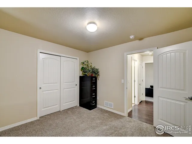 a bathroom with a granite countertop sink a mirror and shower