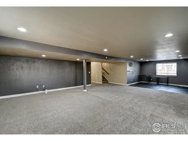 a bedroom with a bed and a night stand