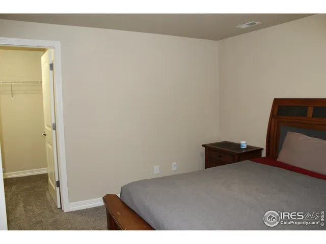 a bedroom with a bed and with furniture